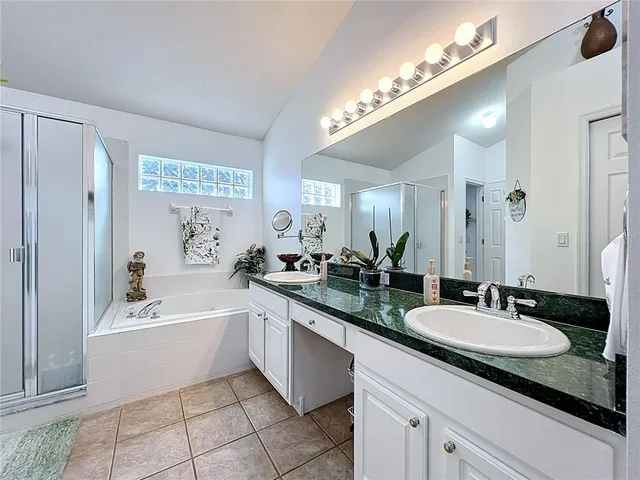 a kitchen with granite countertop a sink stove and refrigerator