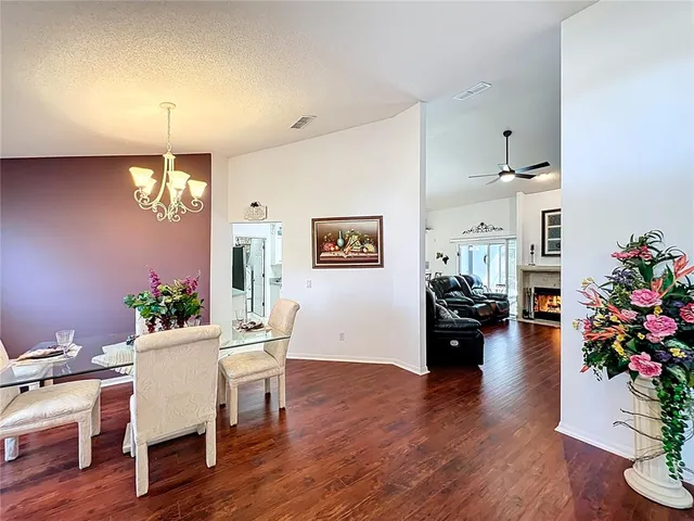 a kitchen with stainless steel appliances a sink dishwasher and white cabinets with wooden floor