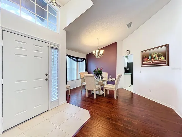 a kitchen with refrigerator a stove a sink and white cabinets