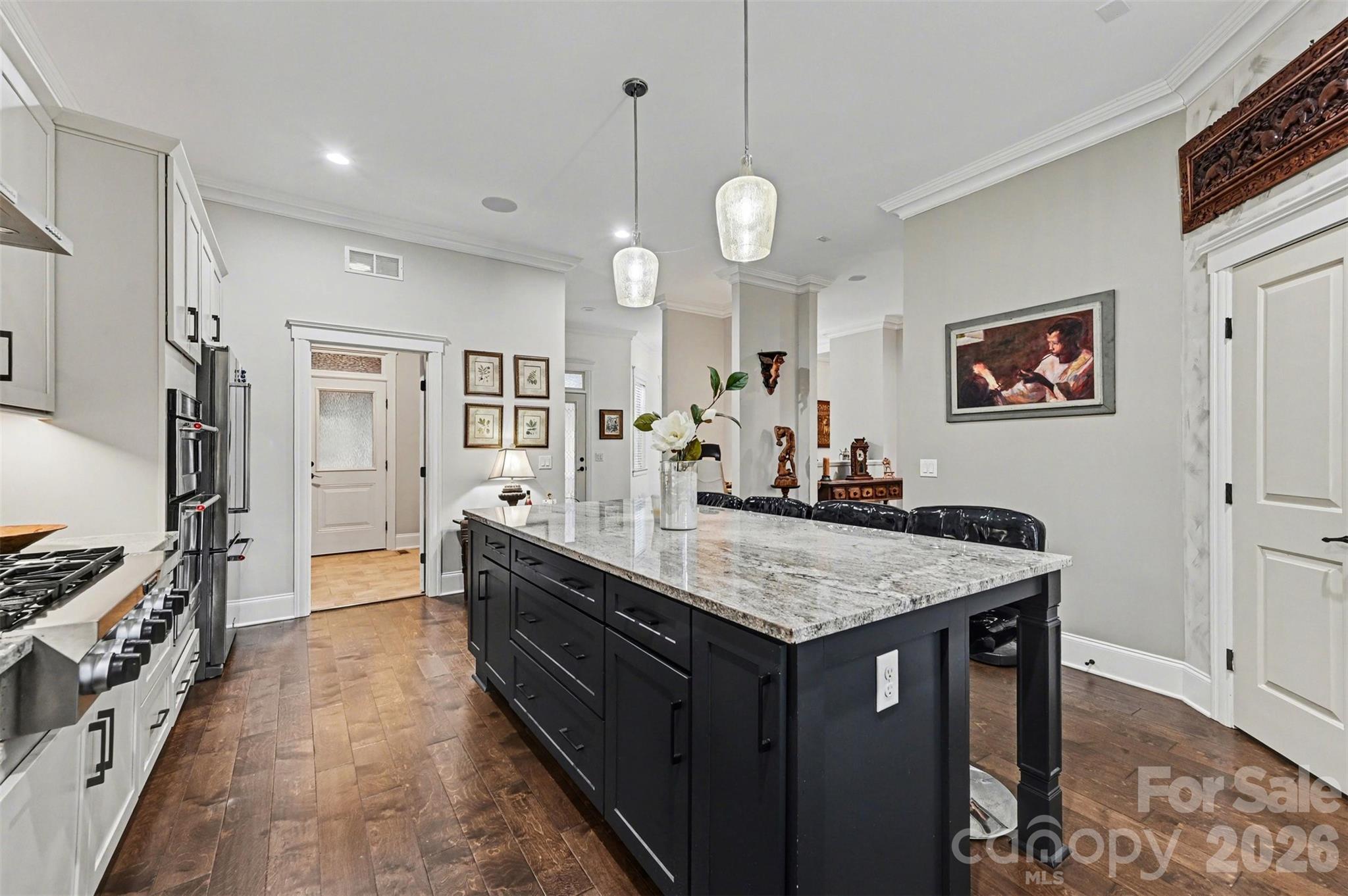 6302 Chimney Bluff Road Lancaster, SC 29720 - Photo 12 of 47 a large kitchen with kitchen island a stove a sink dishwasher and a refrigerator with wooden floor
