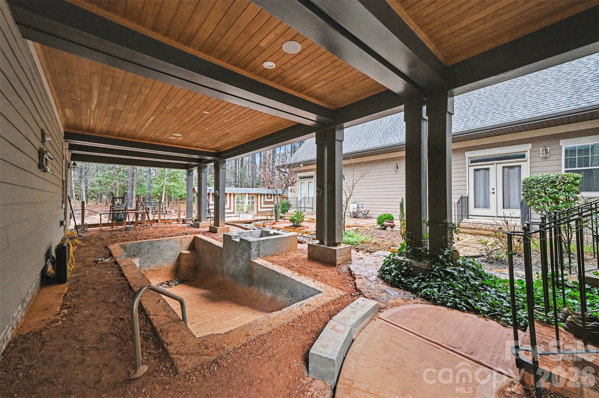 6302 Chimney Bluff Road Lancaster, SC 29720 - Photo 32 of 47 a living room with patio furniture and floor to ceiling windows