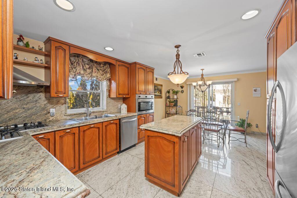 5 Rigimar Court Staten Island, NY 10309 - Photo 13 of 37 a kitchen with granite countertop a sink stove and cabinets