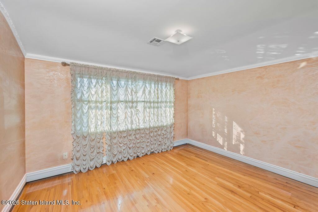 5 Rigimar Court Staten Island, NY 10309 - Photo 16 of 37 a view of empty room with wooden floor and fan