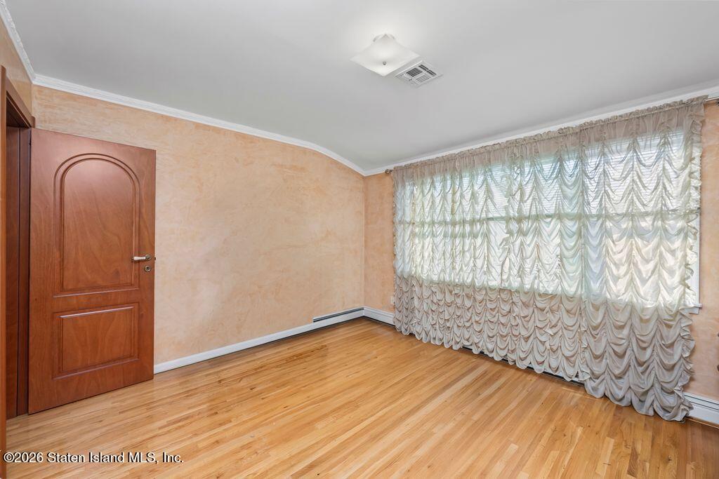 5 Rigimar Court Staten Island, NY 10309 - Photo 17 of 37 a view of empty room with wooden floor and fan