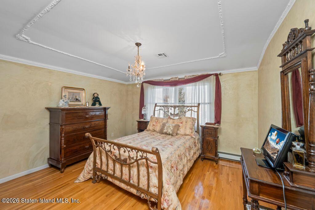 5 Rigimar Court Staten Island, NY 10309 - Photo 21 of 37 a bedroom with a bed and a chandelier