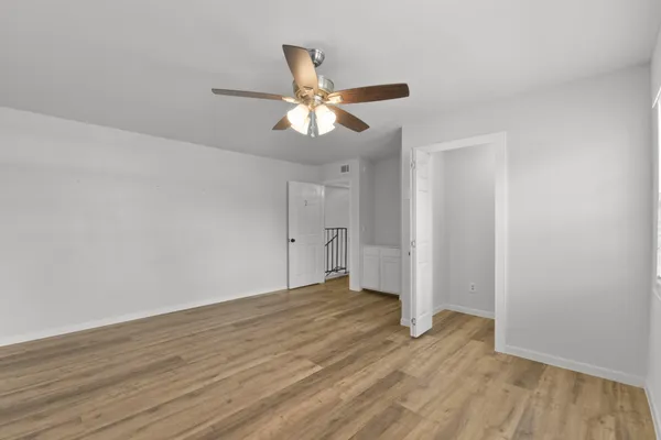 a view of empty room with wooden floor