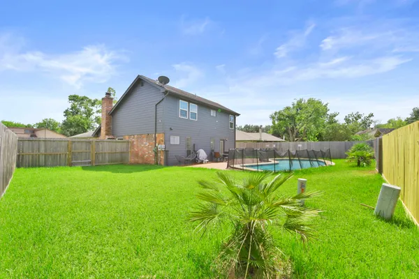 a backyard of a house with lots of green space