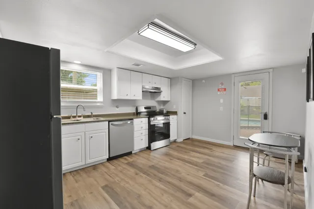 a kitchen with a stove a sink and a refrigerator