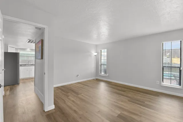 wooden floor in an empty room with a window