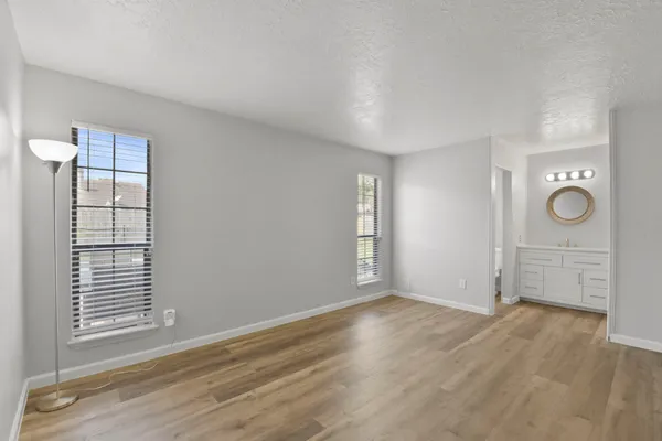 an empty room with windows and closet