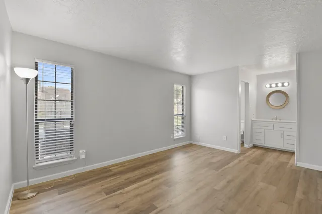 an empty room with windows and closet