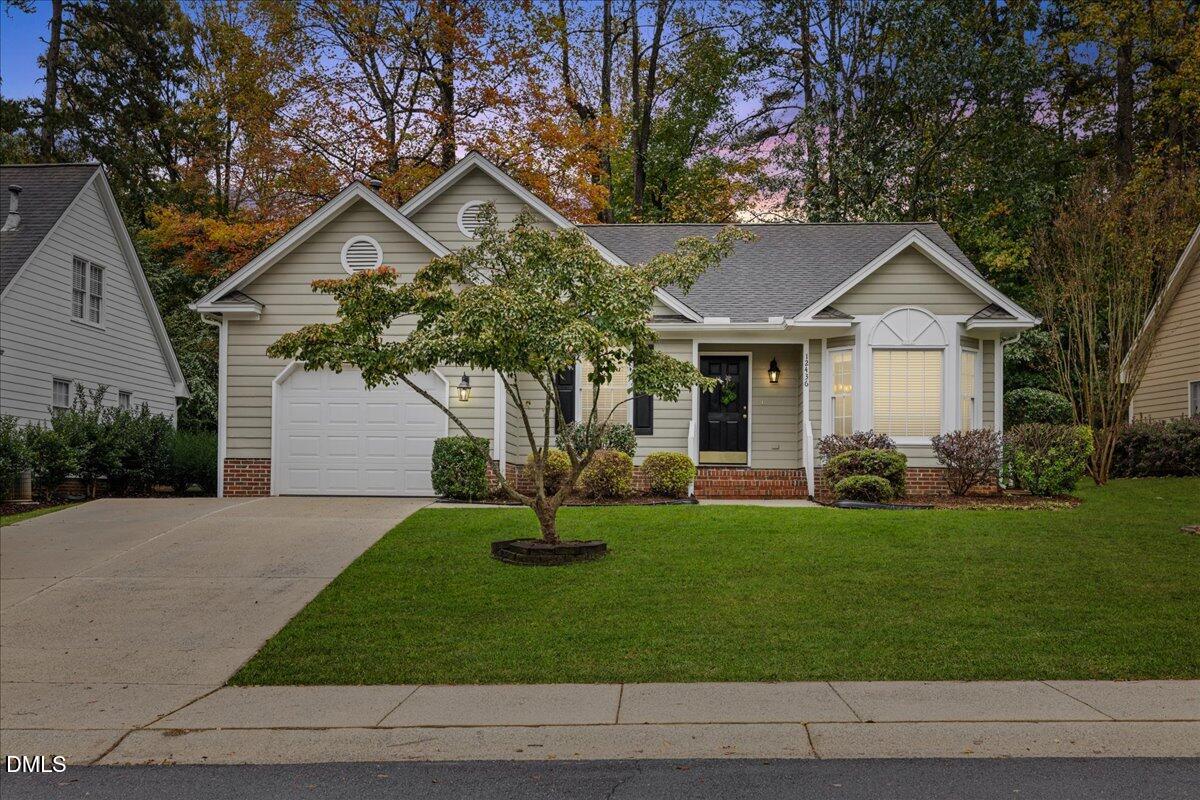 12436 Harcourt Drive Raleigh, NC 27613 - Photo 1 of 29 a front view of a house with a yard and garage