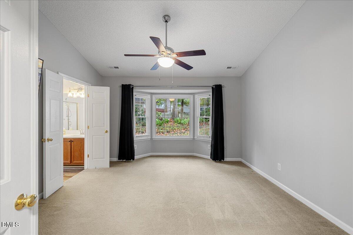 12436 Harcourt Drive Raleigh, NC 27613 - Photo 11 of 29 a view of a livingroom with a ceiling fan and window