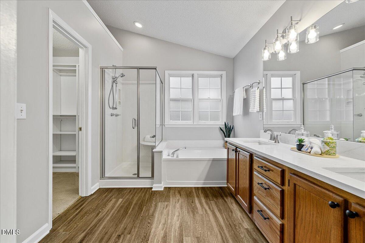 12436 Harcourt Drive Raleigh, NC 27613 - Photo 13 of 29 a spacious bathroom with a tub sink and mirror
