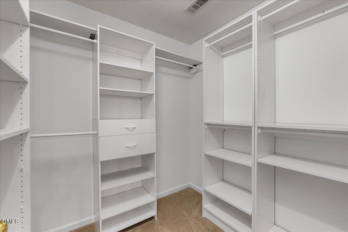 12436 Harcourt Drive Raleigh, NC 27613 - Photo 15 of 29 a view of walk in closet with empty racks