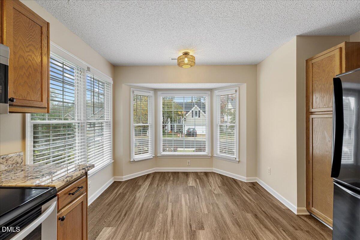 12436 Harcourt Drive Raleigh, NC 27613 - Photo 6 of 29 a view of a kitchen with wooden floor and a window