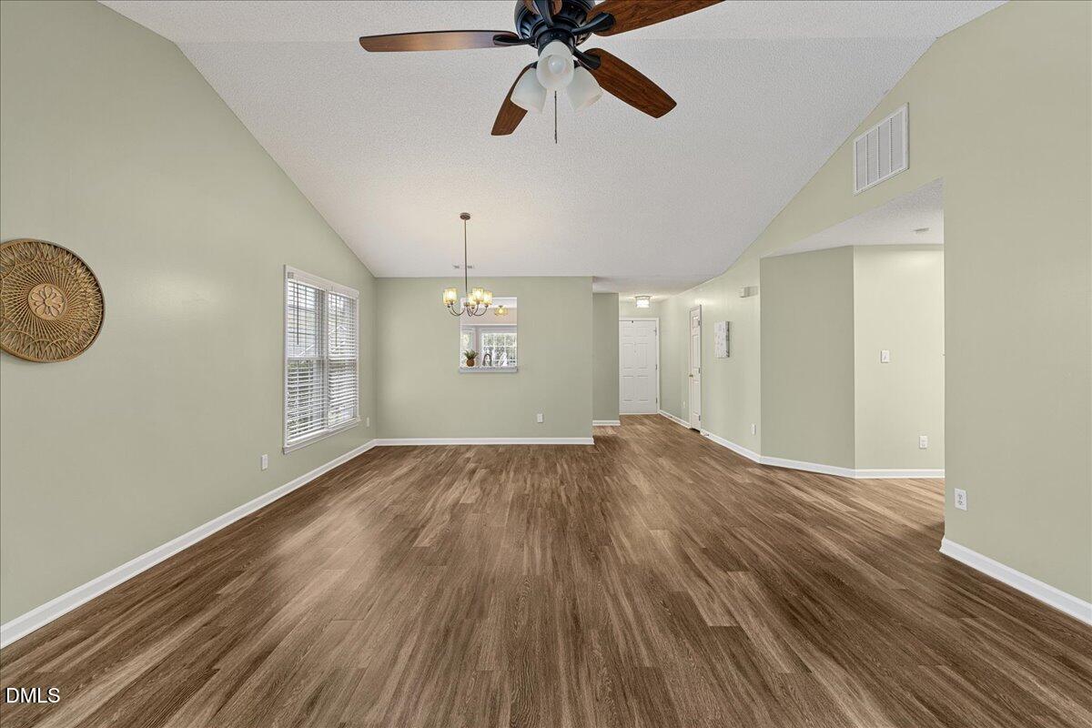 12436 Harcourt Drive Raleigh, NC 27613 - Photo 9 of 29 a view of empty room with wooden floor and fan