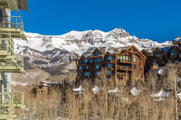 a view of a house with a snow in the background