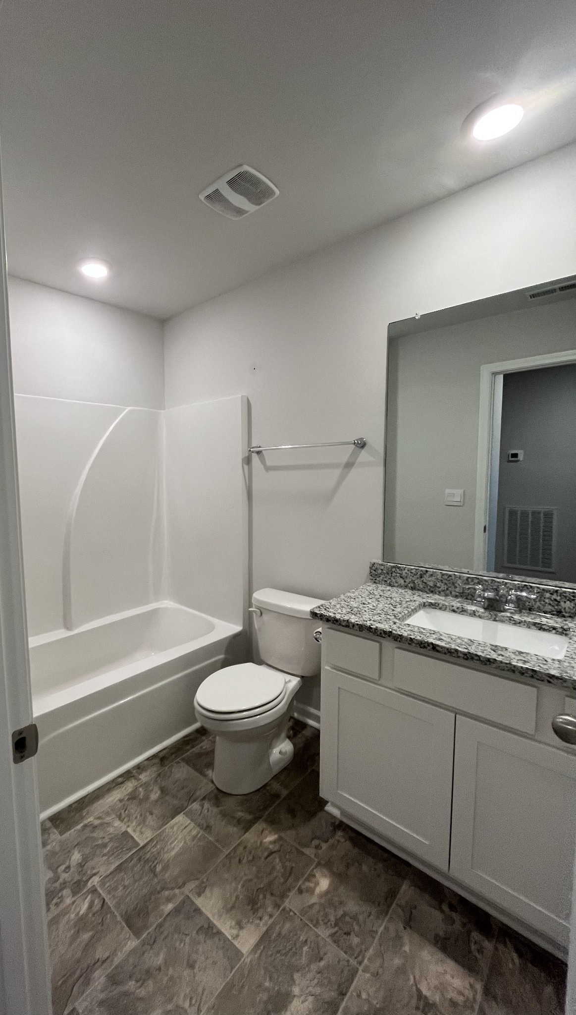 441 Waterfowl Way Lebanon, TN 37090 - Photo 12 of 21 a bathroom with a granite countertop sink toilet and bathtub