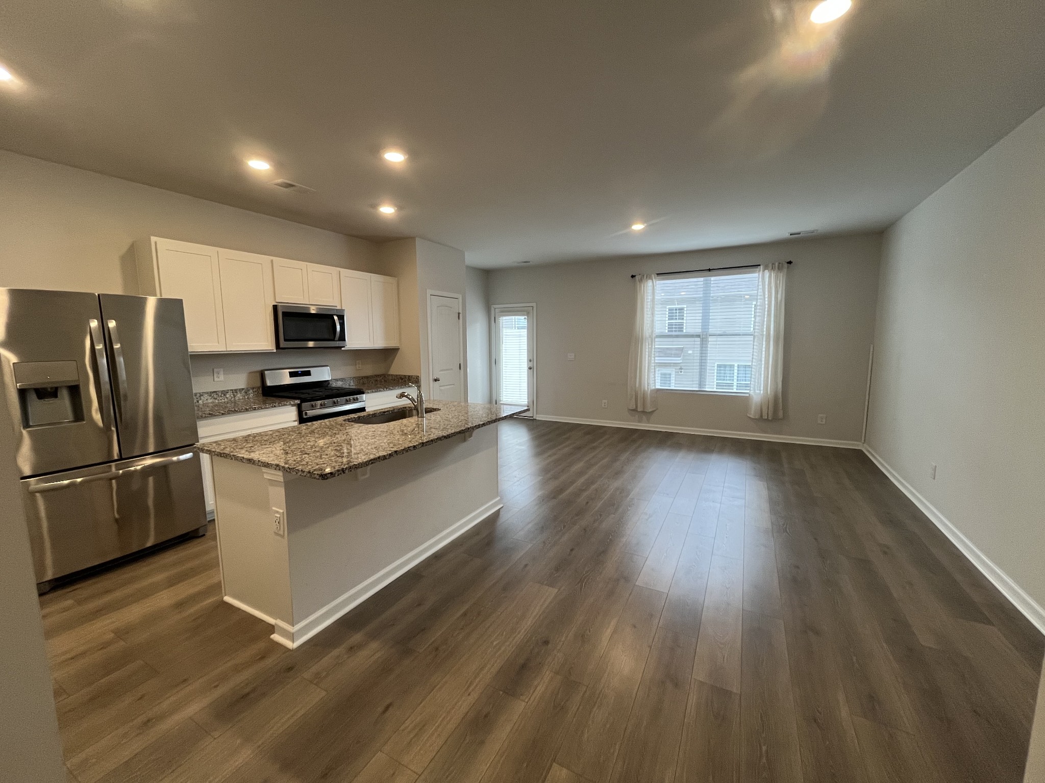 441 Waterfowl Way Lebanon, TN 37090 - Photo 5 of 21 a kitchen with stainless steel appliances a refrigerator microwave and sink