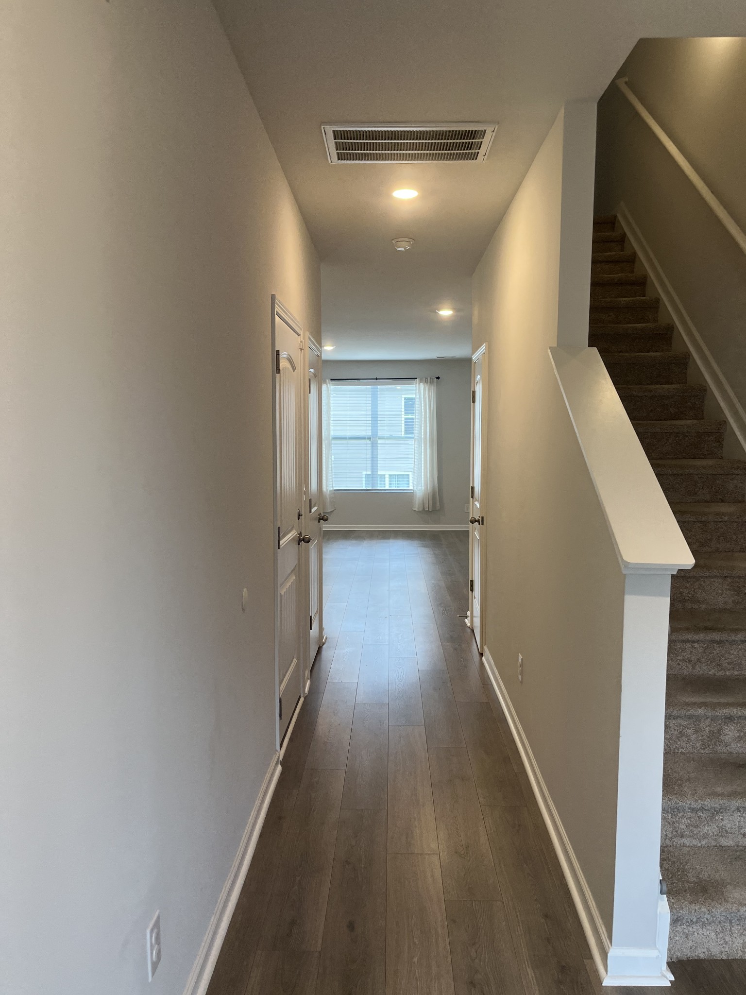 441 Waterfowl Way Lebanon, TN 37090 - Photo 7 of 21 a view of a hallway with wooden floor and staircase