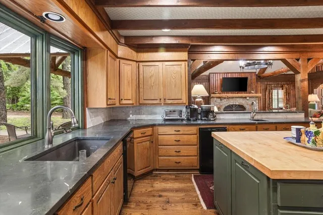 a kitchen with a sink stove and cabinets