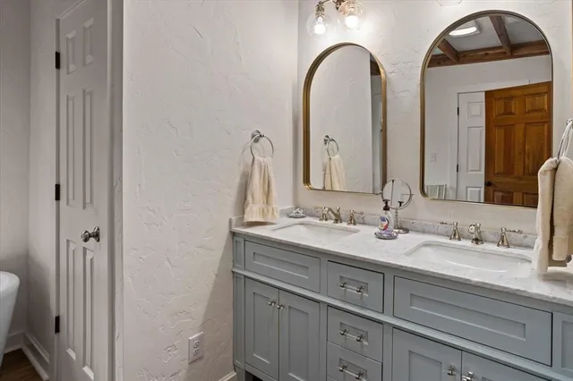a bathroom with 2 sink and a mirror