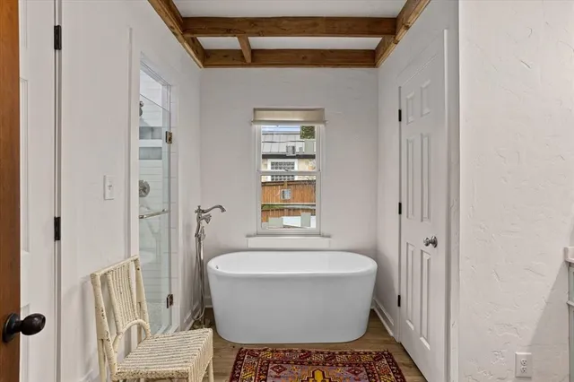 a bathroom with a bathtub and window
