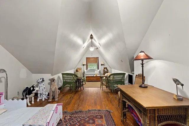 a bedroom with furniture and a wooden floor