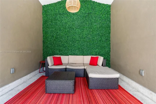 a view of a room with a large window and wooden floor