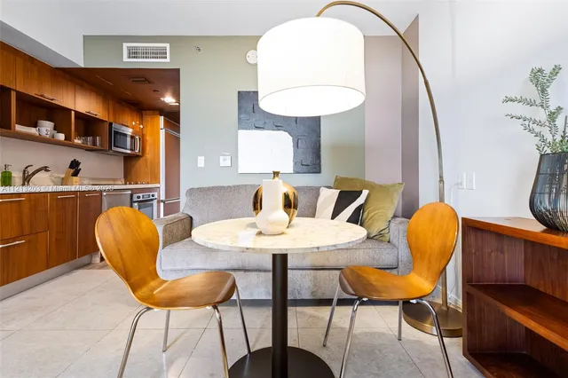 a dining room with furniture and wooden floor