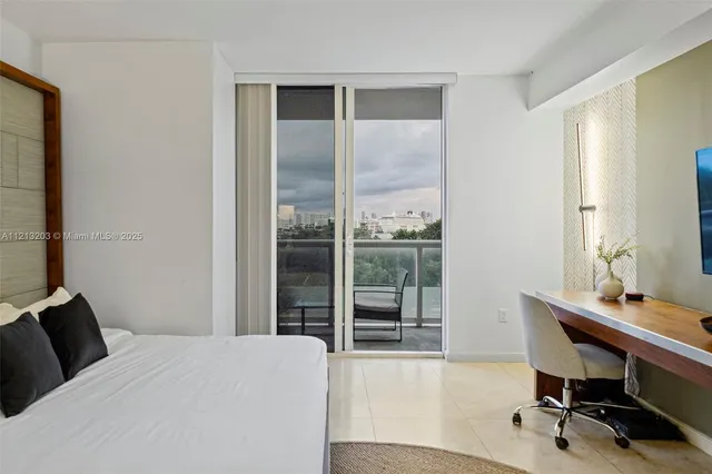 a bedroom with a bed and a desk