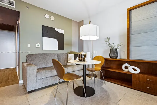 a living room with furniture a lamp and a window