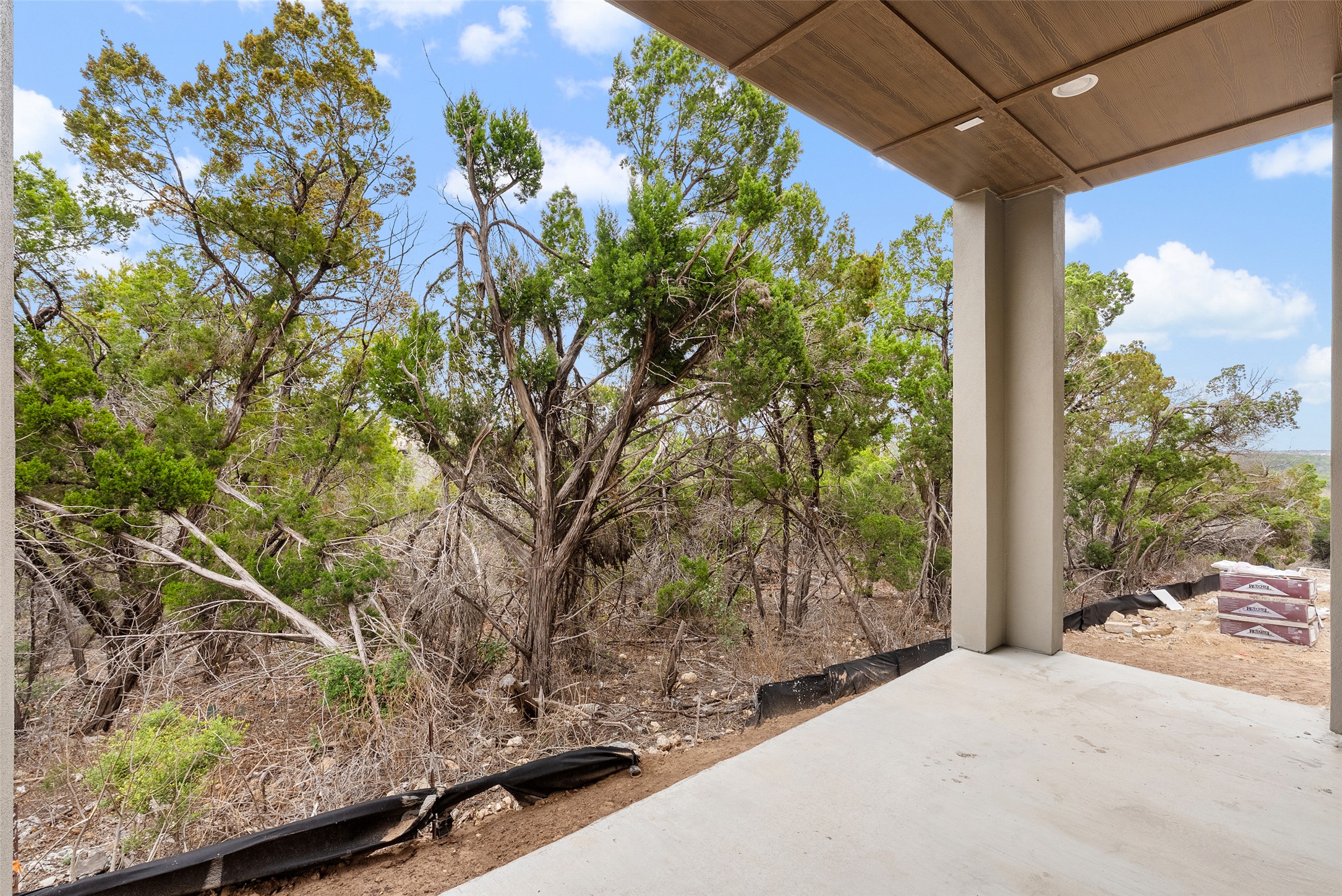 9803 Ribelin Ranch Court, Unit 10 Austin, TX 78750 - Photo 6 of 18 a view of backyard with large tree and wooden fence