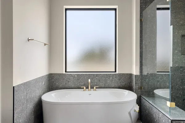 a white bath tub sitting next to a white sink