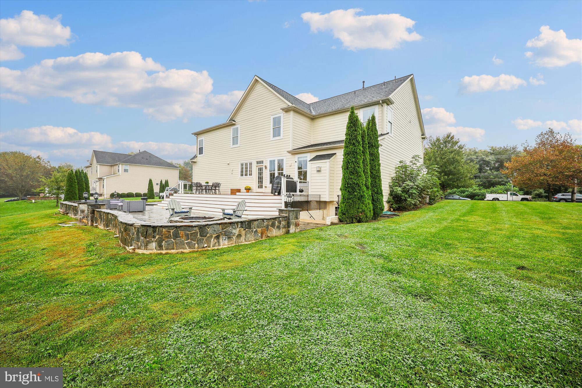 7321 Brink Road Laytonsville, MD 20882 - Photo 33 of 55 a view of a house with a big yard and dinning table and chairs