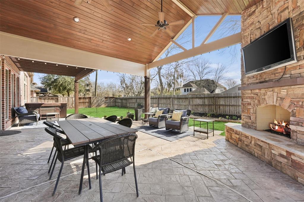 a view of a patio with a table chairs and a backyard