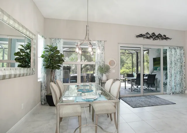 a living room with furniture and potted plants