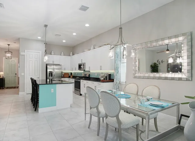 a kitchen with sink cabinets and dining table