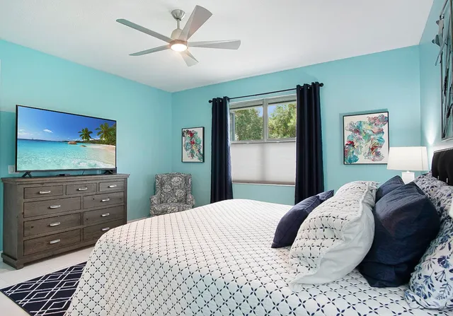 a bedroom with a bed and a flat screen tv