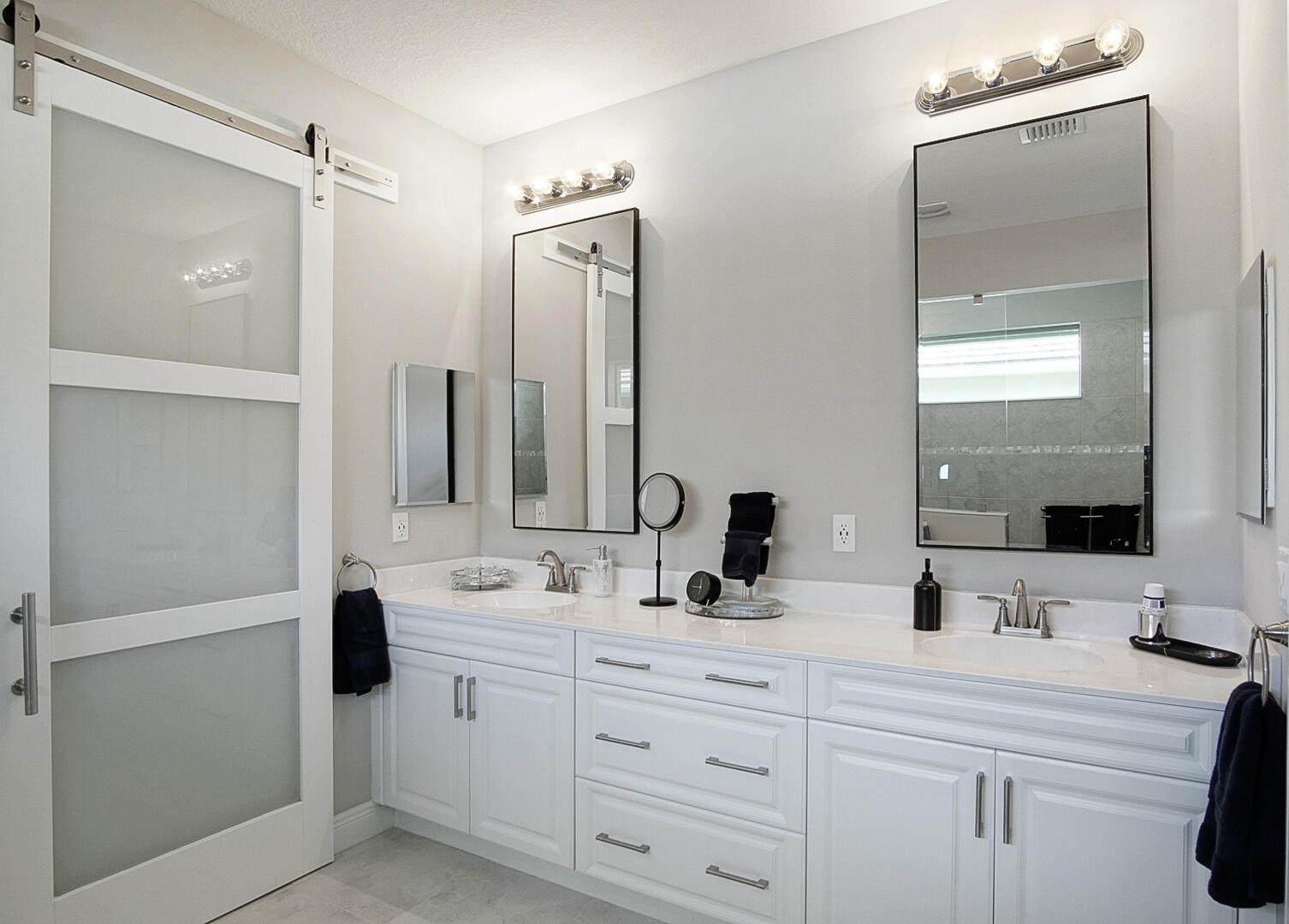 2652 Conifer Drive Fort Pierce, FL 34951 - Photo 23 of 45 a bathroom with double vanity sink a mirror and shower