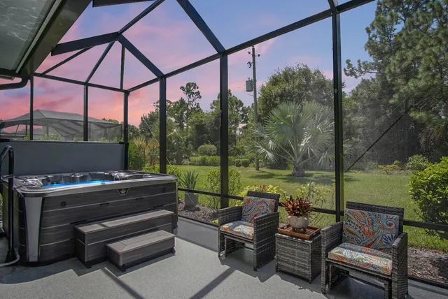 a view of a patio with a table chairs and a backyard