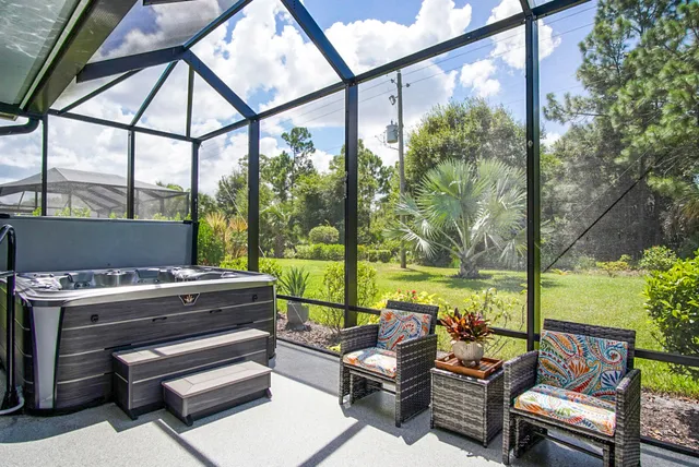 a living room with furniture and a floor to ceiling window