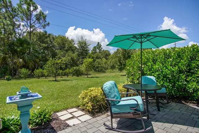 a view of a table and chairs under an umbrella
