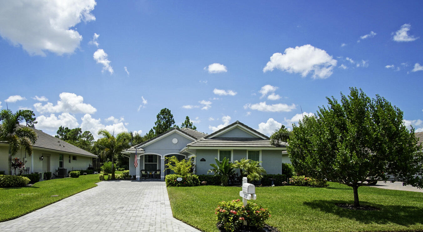 2652 Conifer Drive Fort Pierce, FL 34951 - Photo 45 of 45 a front view of a house with a yard and potted plants