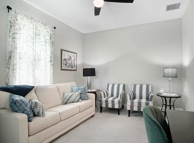 a living room with furniture and a large window