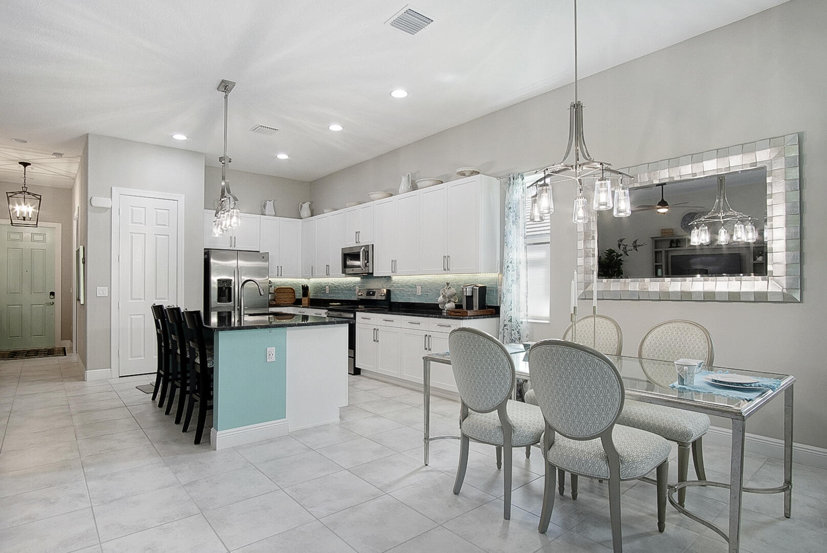 2652 Conifer Drive Fort Pierce, FL 34951 - Photo 9 of 45 a kitchen with stainless steel appliances kitchen island granite countertop a table and chairs in it