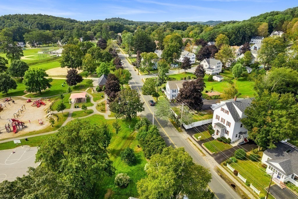 an aerial view of residential houses with outdoor space