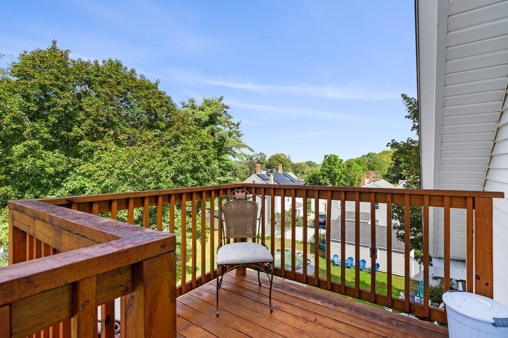 129 Friend Street Amesbury, MA 01913 - Photo 13 of 37 a balcony with wooden floor and fence
