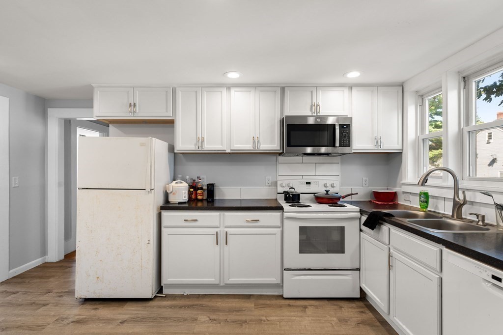 129 Friend Street Amesbury, MA 01913 - Photo 22 of 37 a kitchen with a white cabinets and white appliances